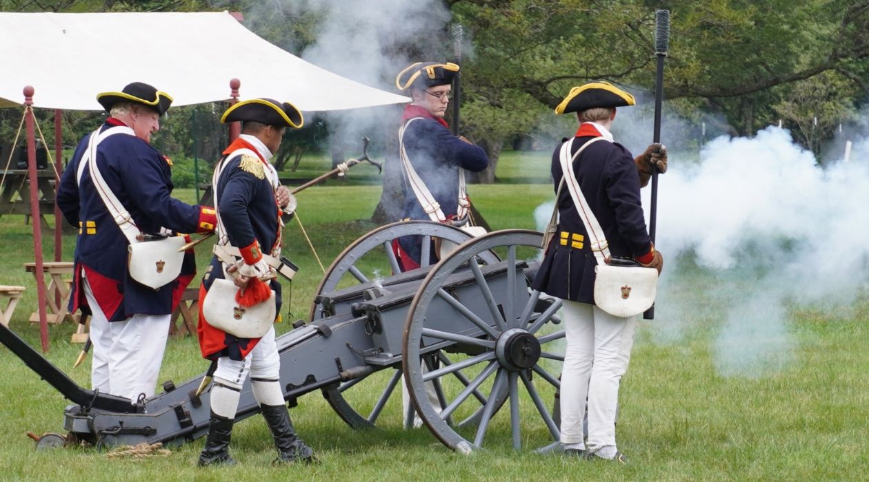 Revolutionary War reenactors fire a cannon during RevCon 2024 at the Franklin D. Roosevelt Presidential Library and Museum in Hyde Park on June 8, 2024